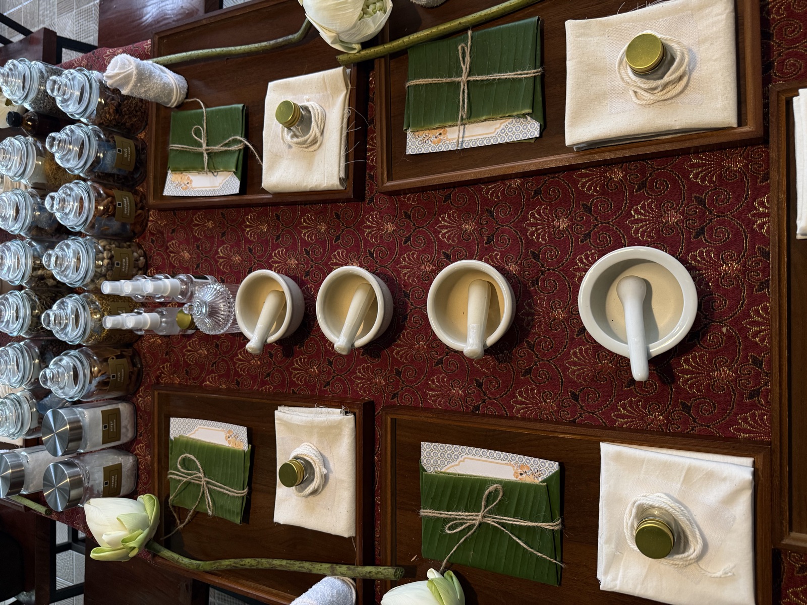 Herbal workshop stations set with mortars, pestles and Thai herb jars